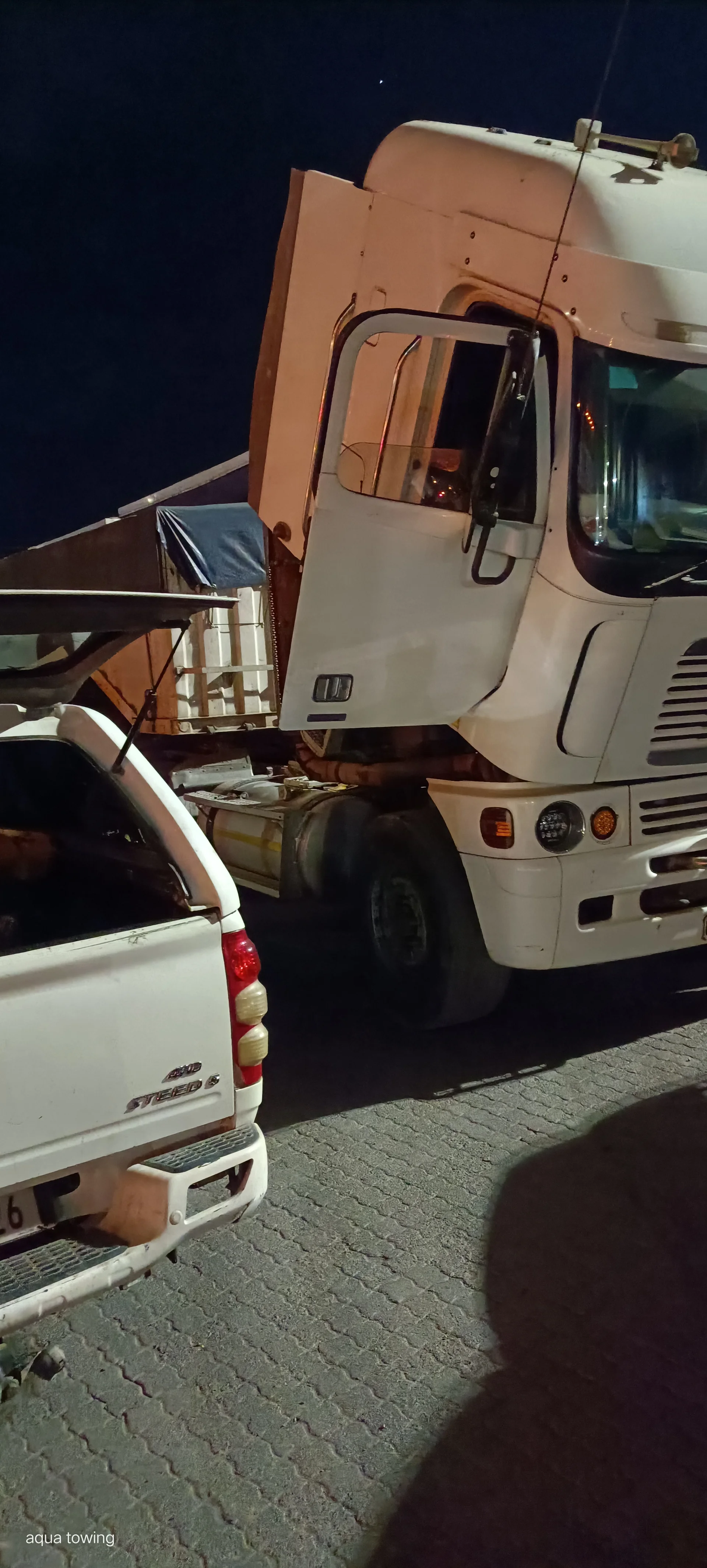 Mechanic repairing a truck engine with hand tools